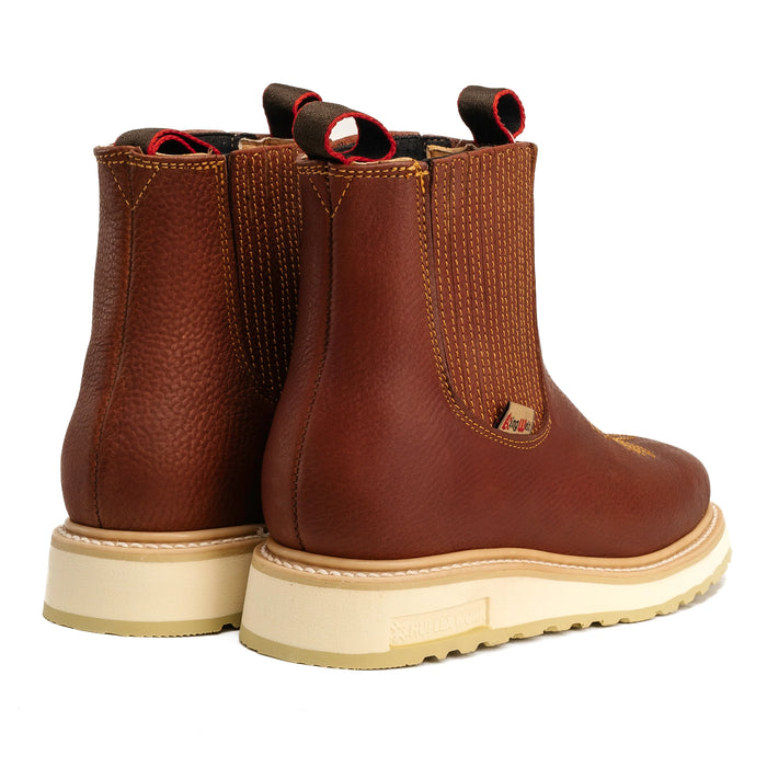 Pair of brown leather boots with beige soles on a white background