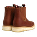 Pair of brown leather boots with beige soles on a white background