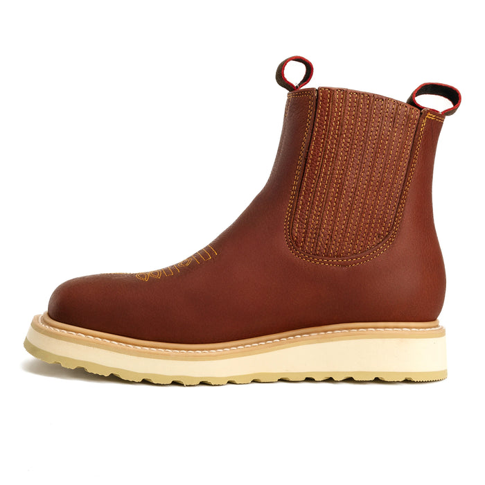 Brown leather boot with a white sole on a white background