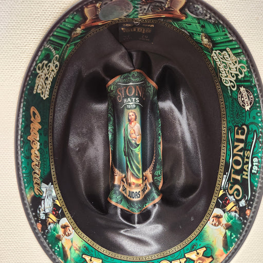 Decorative hat with a cylindrical object inside, featuring intricate designs and text.