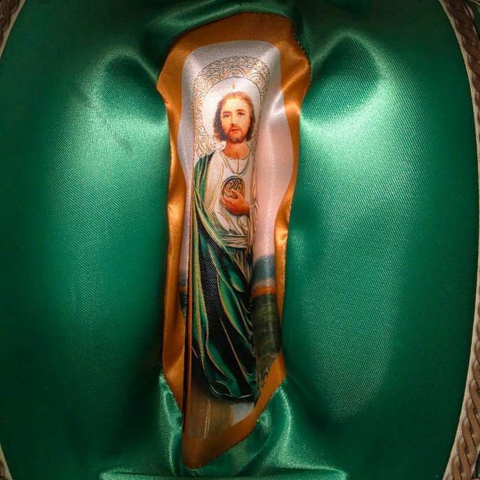 A religious icon plaque depicting Jesus Christ and the Virgin Mary, mounted on a gold-colored ribbon and displayed inside a green satin-lined presentation box.